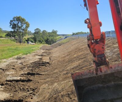 Heavy machinery performing bulk earthworks for a civil development project.